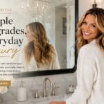 The Mirror That Finally Made My Bathroom Look Finished Black framed vanity mirror hanging vertically in a modern farmhouse bathroom