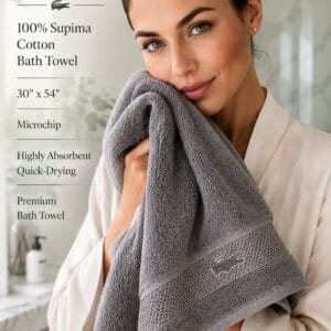 Lacoste Heritage 100% Supima cotton bath towel in Microchip grey, 30 by 54 inches, folded to show the embroidered crocodile logo