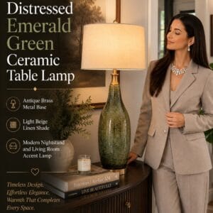 Distressed emerald green ceramic table lamp with antique brass metal base and light beige linen drum shade styled on a modern nightstand