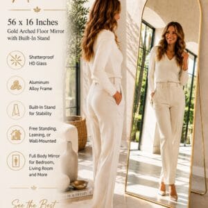 56 x 16 inch gold arched full length floor mirror with aluminum frame leaning against a bedroom wall
