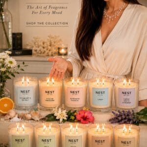 NEST New York Bamboo 3-wick scented candle in a frosted striped glass vessel lit on a styled console table