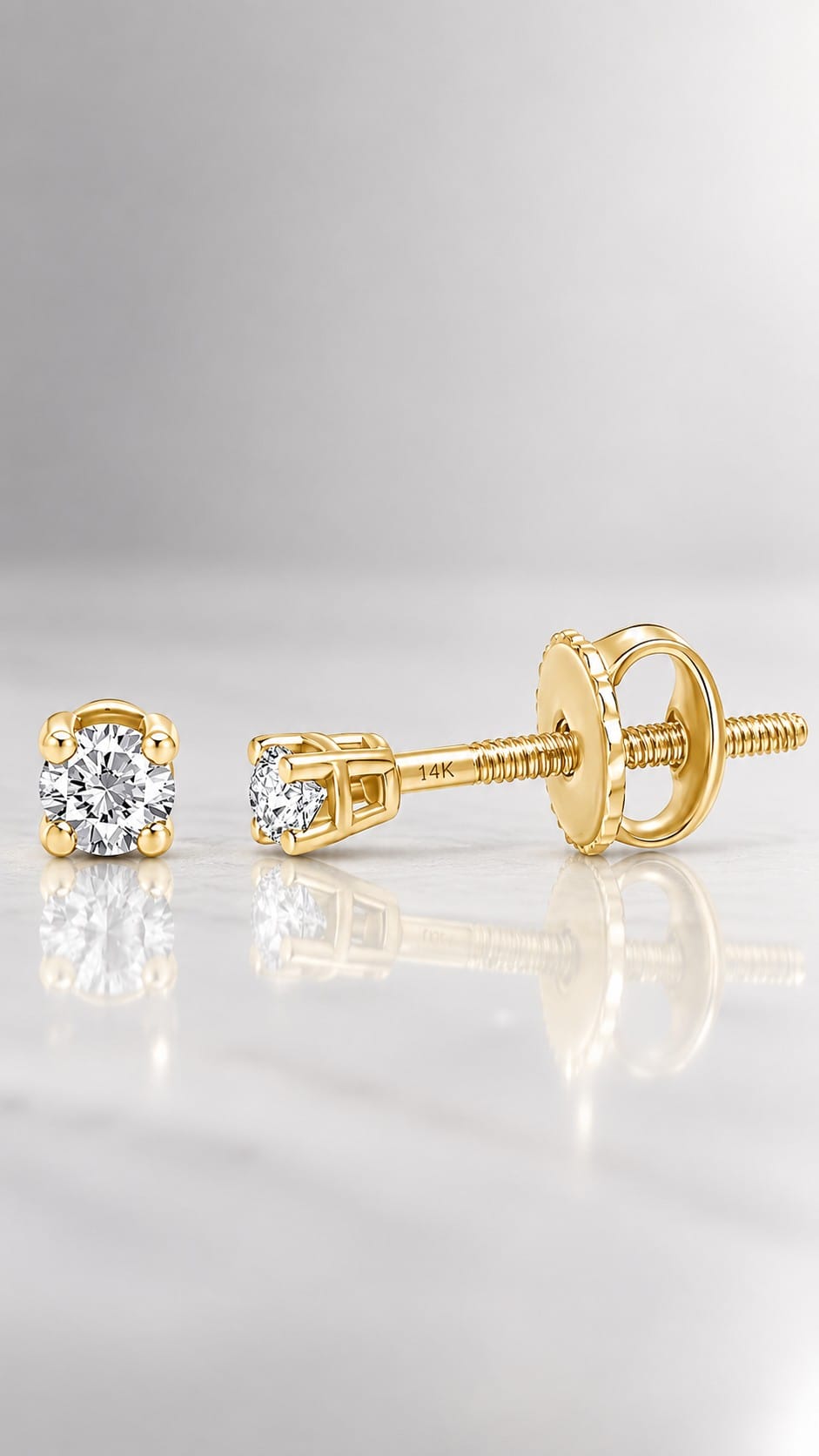 Tiny round diamond studs in solid 14K gold with screw backs